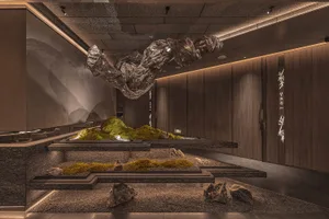 A large sculpture made of various rocks and stones in a room with a wooden door, creating a creative and imaginative environment