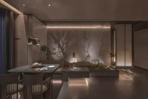Empty modern living room with grey stone flooring, two dining tables, chairs, and potted plants, featuring a clean and minimalist design