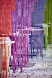 A casual dining area with various chairs and tables, providing ample seating for guests in a warm and inviting atmosphere