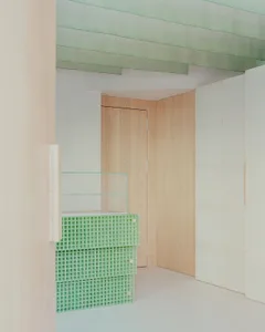 A calm and peaceful hallway made of wood with an open doorway leading to a hallway