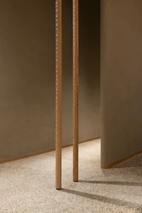 A dimly lit hallway with wooden walls featuring vertical panels and columns extending into the distance