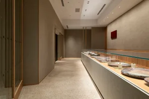 A calm and inviting empty room with a carpeted floor, suitable for a lobby or hallway in a building