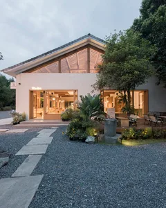 A welcoming restaurant space with a large open area, chairs, and a dining table, suggesting a comfortable environment for guests