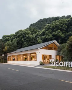 Cozy coffee shop with modern wood and glass elements, featuring a contemporary interior with seating areas, potted plants, and a vase on a table