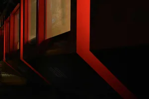 A warm interior space with red walls and a window