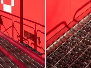 Image of a staircase with red walls and a metal railing, possibly a building's exterior with a concrete structure