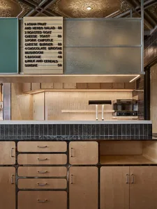 Kitchen with wooden cabinets, countertops, and appliances, featuring a casual and inviting atmosphere with a focus on food preparation and storage