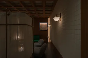 Cozy living space with a couch, two chairs, and a large window allowing natural light to fill the space