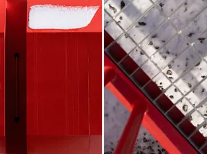 A modern structure with red and white colors, featuring wood accents and snowy conditions, with varying lighting sources creating a dynamic atmosphere