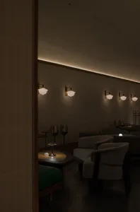 A modern cafe with a large dining area featuring brick walls, multiple chairs, and tables, with clean lines and minimalistic decoration