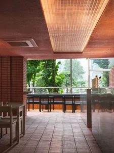 Dining area with red brick walls, natural light, and comfortable seating for guests