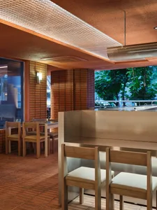 Warm and inviting restaurant interior with wooden tables and chairs, well-thought-out lighting, and a rustic atmosphere
