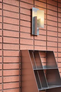 A brick wall with a modern metal shelf attached, creating a unique blend of textures and materials in a possibly indoor living or storage space