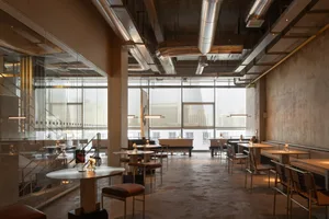 Modern restaurant interior with artwork, natural light, and ample seating options