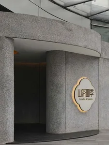 灰石飯店入口，醒目招牌寫著 Canelo Seasons，置於中性背景前