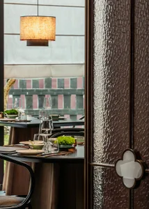 A dining area with a table set for a meal, surrounded by chairs and decorative elements, creating a sophisticated atmosphere