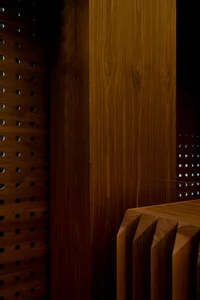 Warm and inviting interior space with wooden walls and floors, featuring two wooden benches