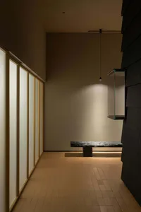Bright and inviting open office space with glass walls, a bench, and natural light