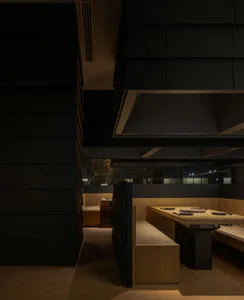 Cozy restaurant interior with wooden tables and chairs, dimly lit for an intimate ambiance