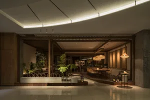A modern dining area with multiple tables and chairs, surrounded by potted plants and a stylish atmosphere