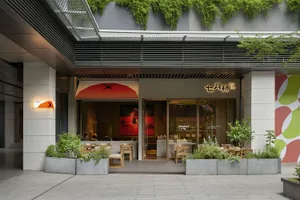 Modern Asian restaurant with a large window, wood and metal elements, and comfortable seating for dining