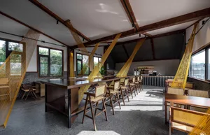 Inviting open concept restaurant with multiple dining tables and chairs, creating a spacious atmosphere for guests to enjoy their meals together