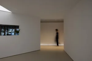 Empty hallway with white walls and floors, creating a clean and minimalist atmosphere