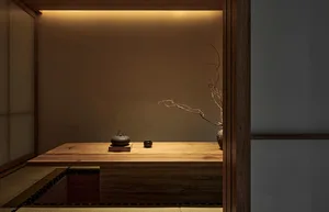 Warm and inviting living space with a wooden table, vases, and bowls, featuring cozy wooden elements