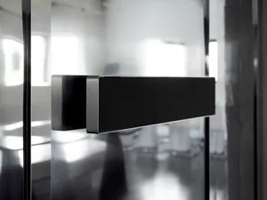 Modern interior design with a sleek glass door, clean lines, and minimalistic elements