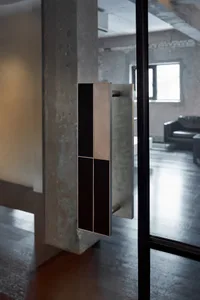 A minimalist entrance with a modern metal and glass door handle, set against a clean and well-lit background