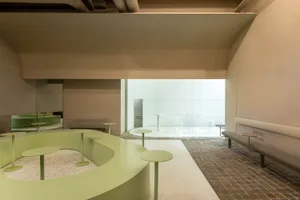 An open space with tables and chairs, circular tables, natural light, and a comfortable atmosphere