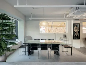 A modern dining space with a clean and bright appearance, featuring a dining table and chairs in a minimalist setting