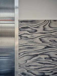 A concrete wall with a large metal sheet on display, giving it a sturdy and industrial appearance
