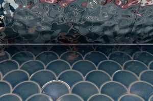 Aqua-colored tile floor with a unique pattern in a bathroom, creating a calm and relaxing atmosphere with a soothing blue color scheme