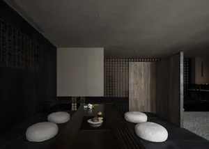 A calm and inviting dining space with a wooden table, chairs, vases, and potted plants