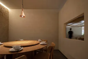 Empty dining area with a wooden table and chairs, surrounded by calm and inviting atmosphere