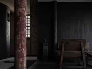 A dark dining space with a wooden table and chairs, surrounded by a black wall