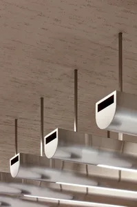 A modern space with a ceiling featuring multiple silver pipes arranged in various directions, creating a unique design element