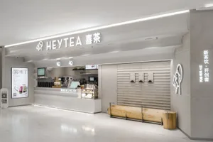 A clean and inviting Asian restaurant with a white interior, featuring a counter and dining area with chairs and tables, and cups on surfaces