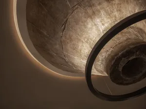 A stone staircase in a museum setting, illuminated by sunlight, with a classic and historic feel