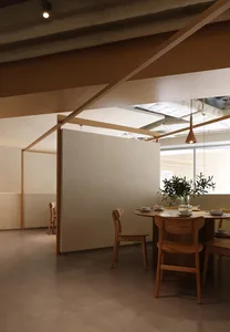 An inviting restaurant with wooden chairs and tables, white walls, and a warm atmosphere