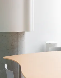 A professional office setting with a wooden table surrounded by two chairs and a sense of organization