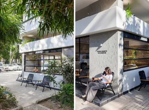 專業辦公大樓配戶外座位區與室內工作空間，內有人員與家具
