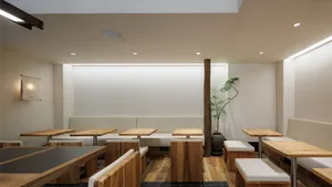 Empty restaurant interior with wooden tables and chairs, clean and well-organized space ready for customers