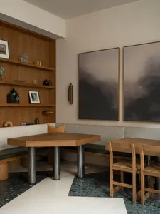A warm and inviting restaurant interior with wooden tables and chairs, suitable for larger groups or families