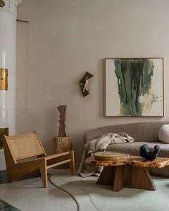 Cozy modern living space with a couch, chair, and dining table, featuring wood elements and neutral tones