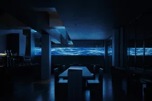 Dark and moody restaurant with a large dining table and chairs, perfect for intimate gatherings
