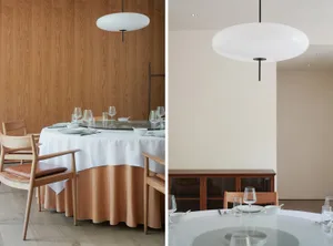 Dining area with wooden furniture, wine glasses, and bowls on a wooden table, set in a warm and inviting space