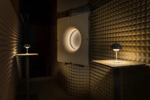 Modern interior design showroom with round mirrors, white and black frames, and minimalist tables