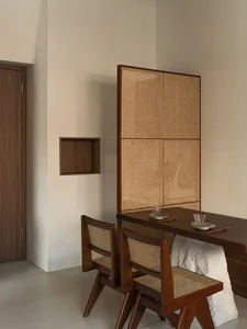 A cozy dining area with a wooden table and chairs, two cups on the table, and a warm atmosphere